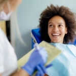 A holistic dentist checks in with a patient